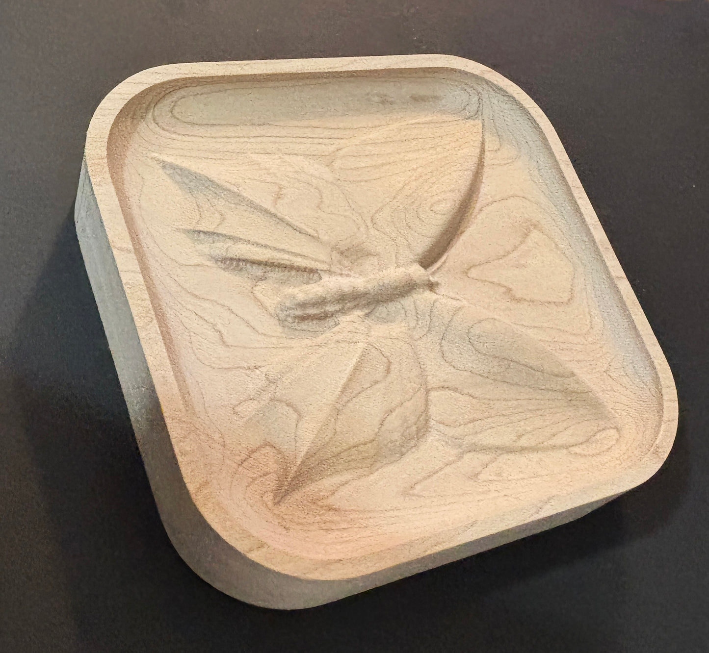 Wooden dish with butterfly design.