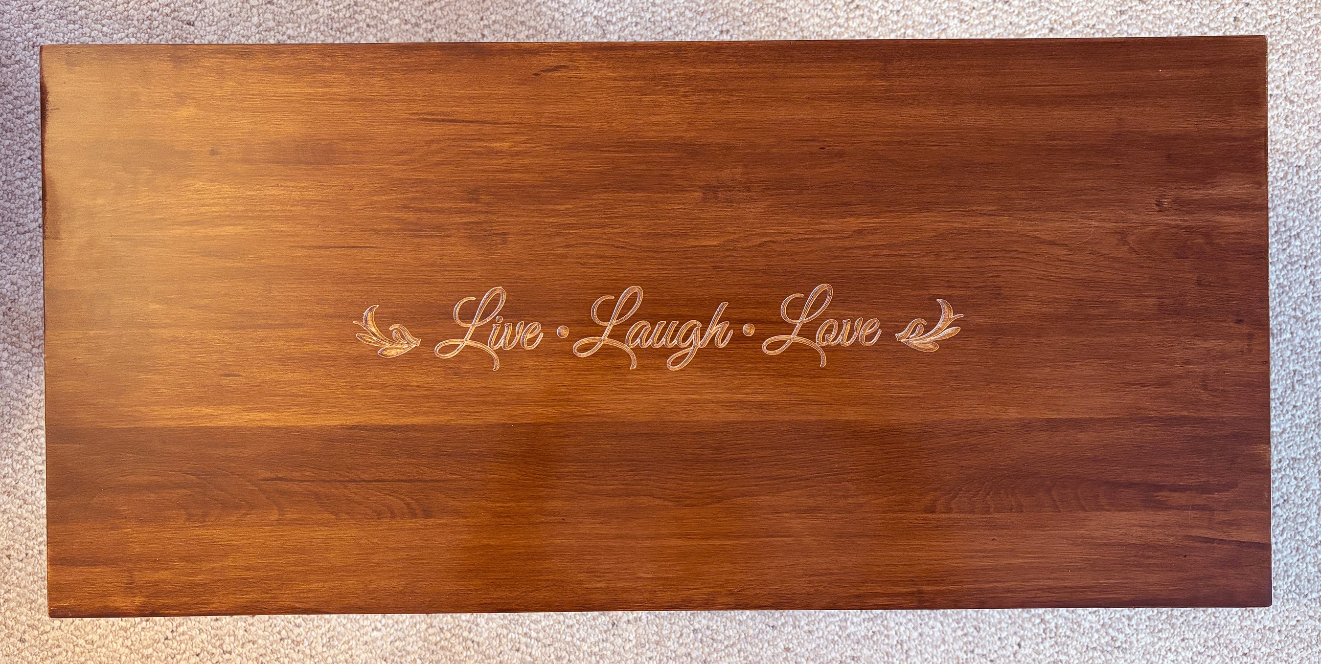 Custom engraving on a wooden bench "Live Laugh Love"