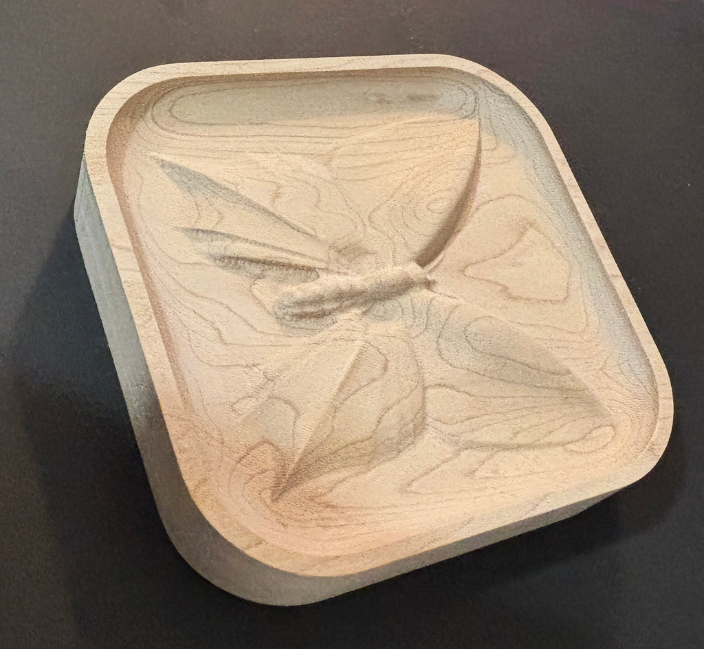 Wooden dish with butterfly design.