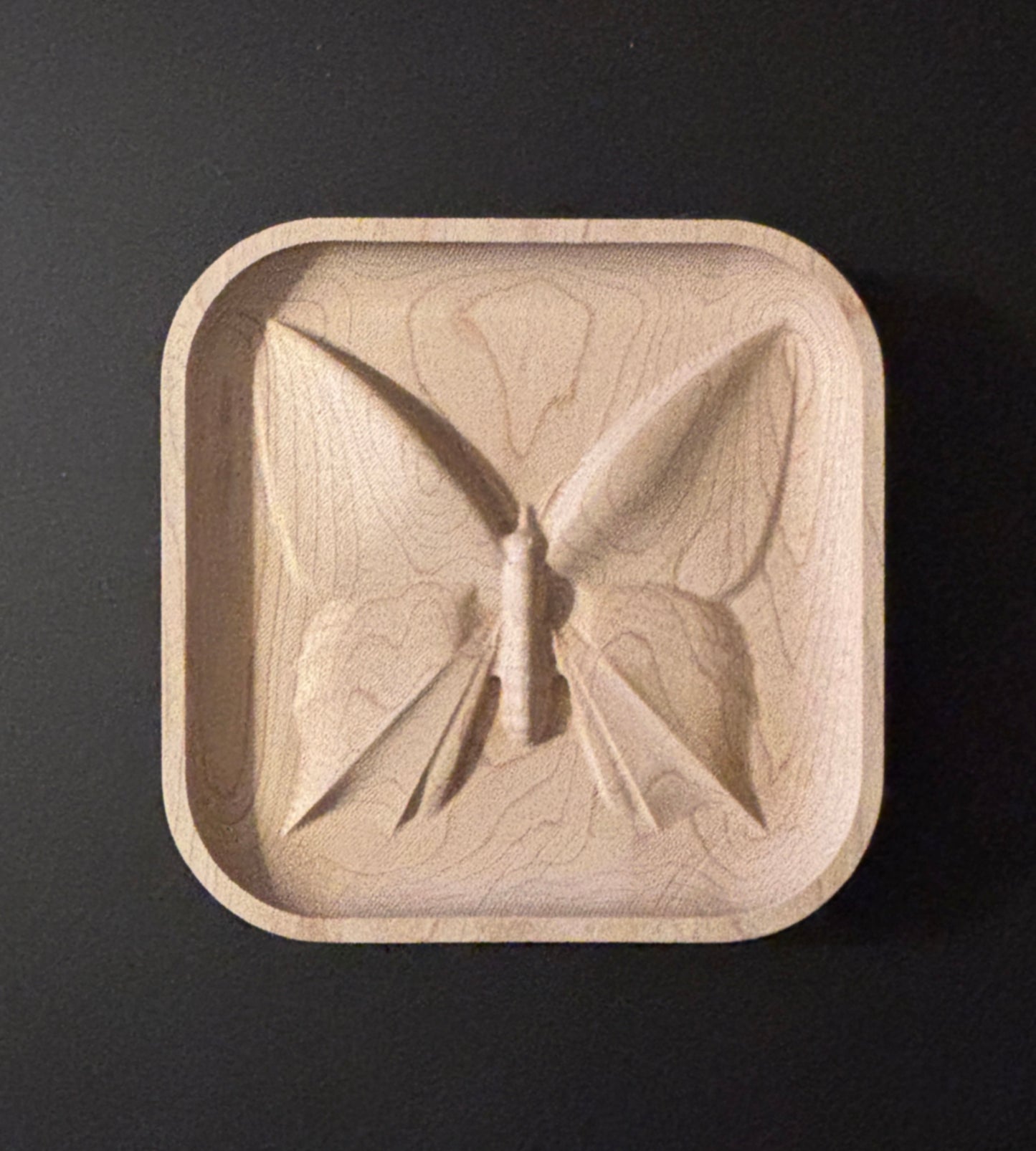 Wooden dish with butterfly design.