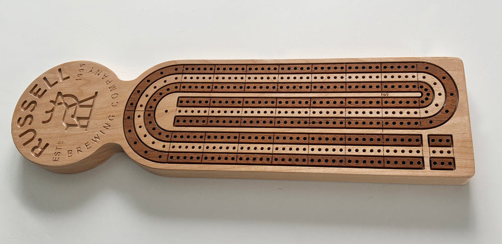 Inlayed, wooden cribbage board with custom branding.