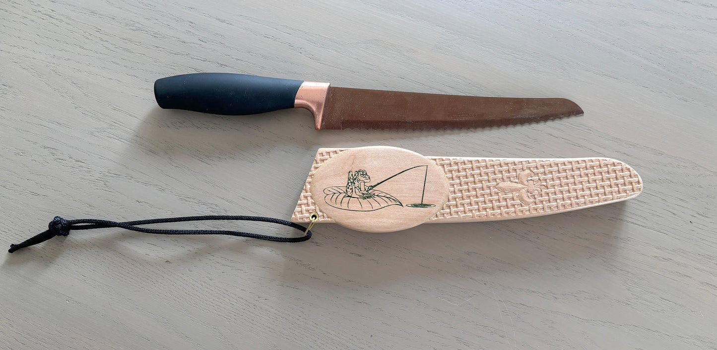 Carved wooden knife sheath.
