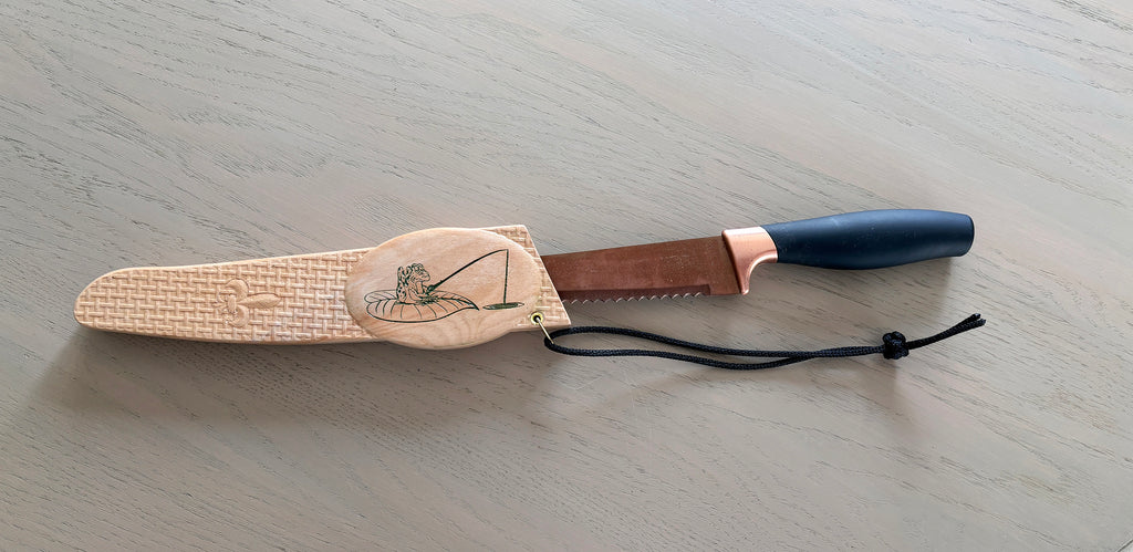 Carved wooden knife sheath.