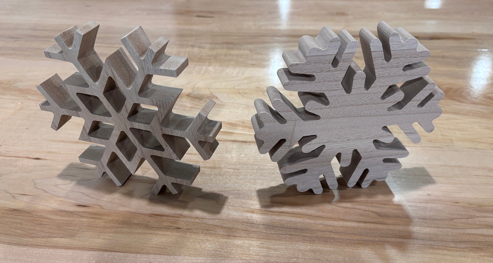 Two wooden snowflake ornaments